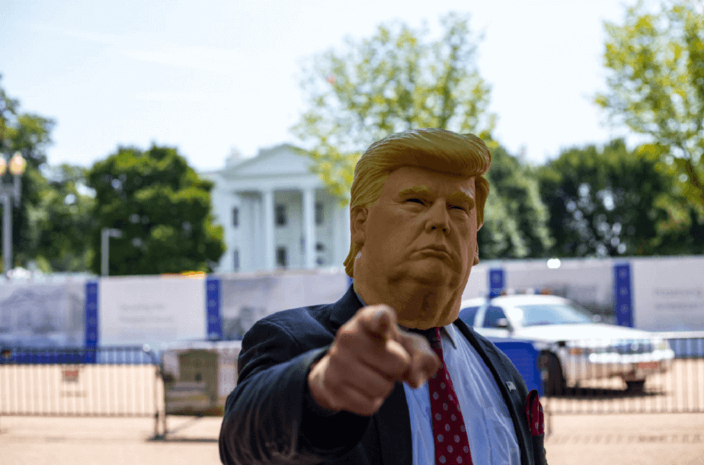 Man wearing Donald Trump mask standing in front of White House