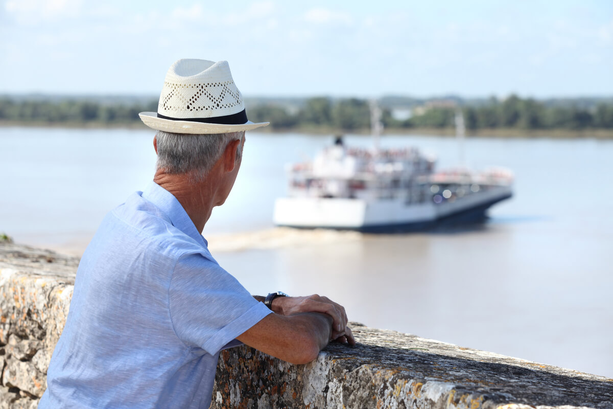old man looking at boat