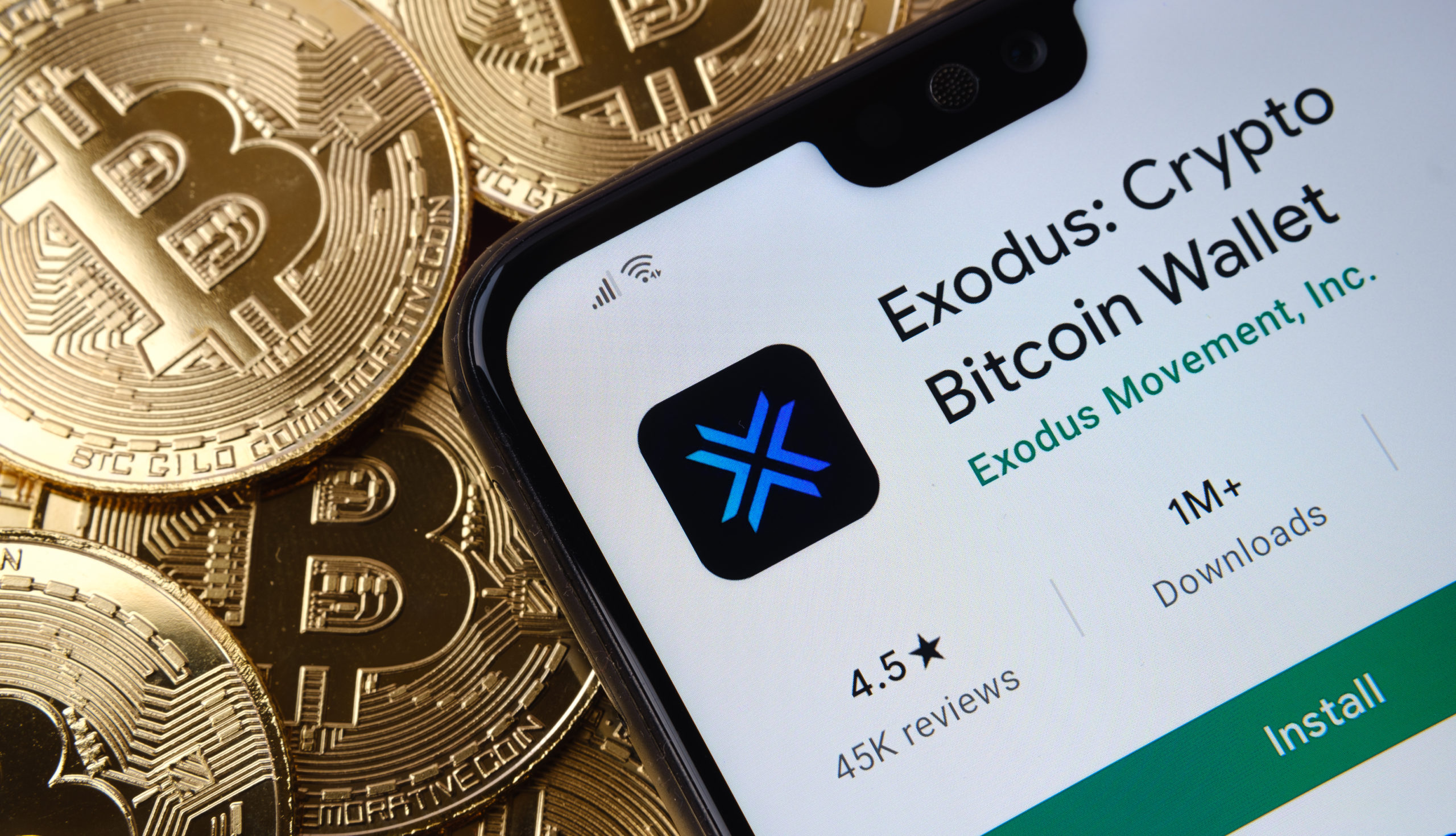 Exodus software on a mobile set on a bed of Bitcoins