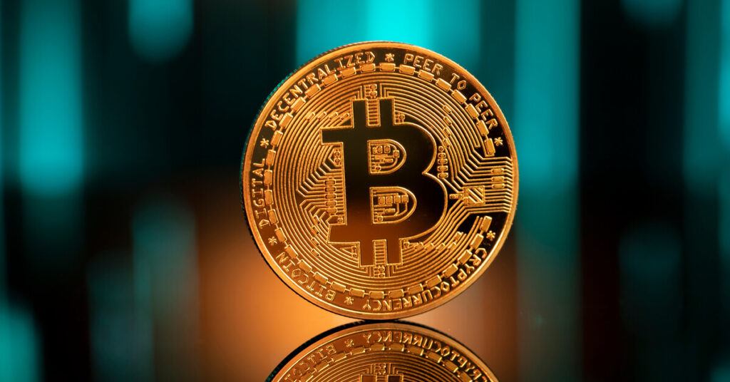 Golden Bitcoin witha graphic in background