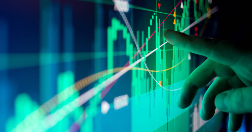 Finger pointing at lime green price chart