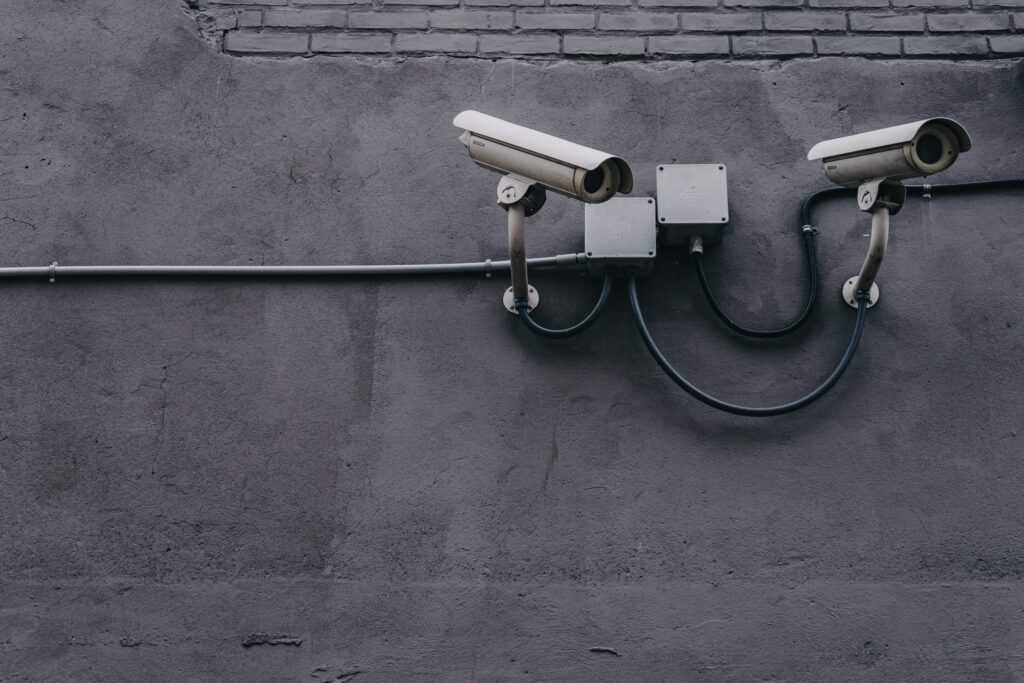 CCTV cameras mounted on a grey wall