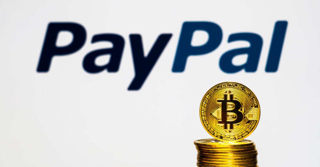 Paypal logo in the background with Bitcoin at the front