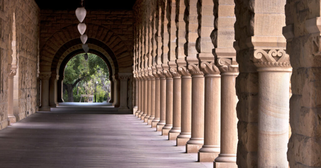 A long outdoor corridor, with concrete pillars