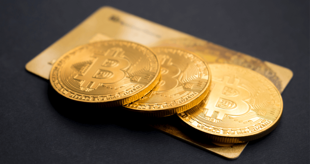 Gold Bitcoins on Top of a Gold Credit Card