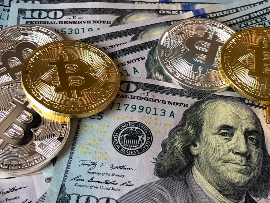 Gold Bitcoins on USD bank notes