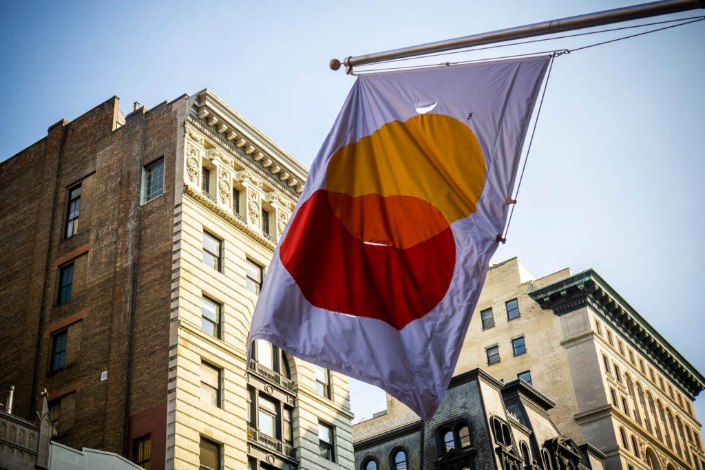 mastercard flag with buildings in the background