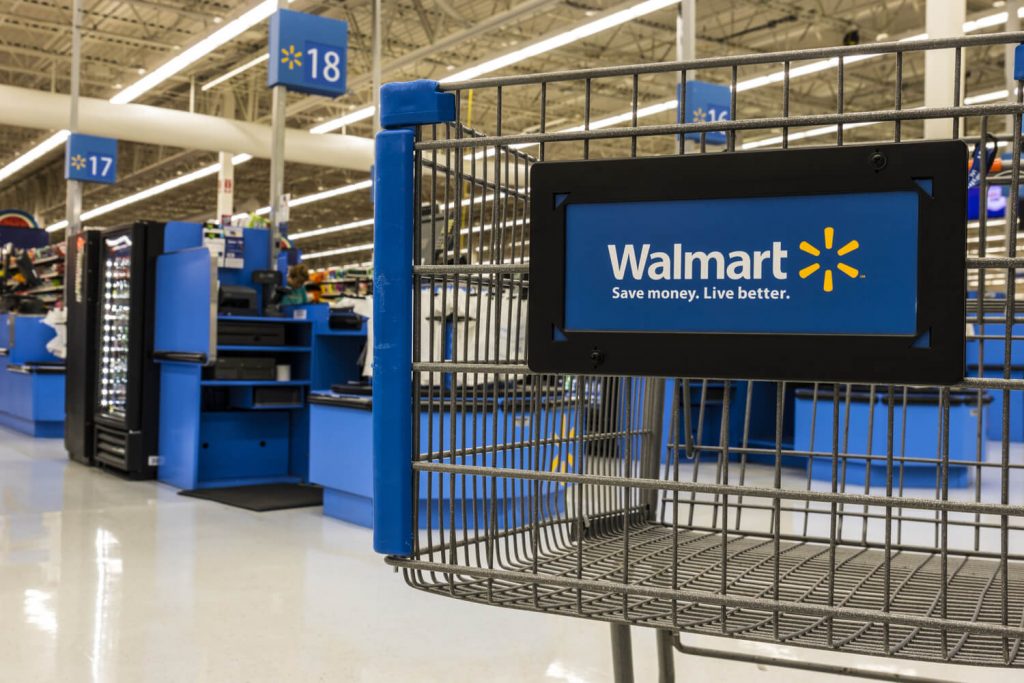 A trolley inside a Walmart store with a Walmart logo on it