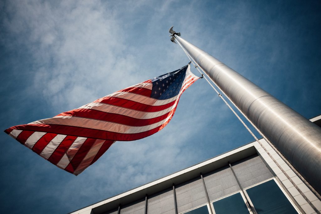 American flag waving at half staff