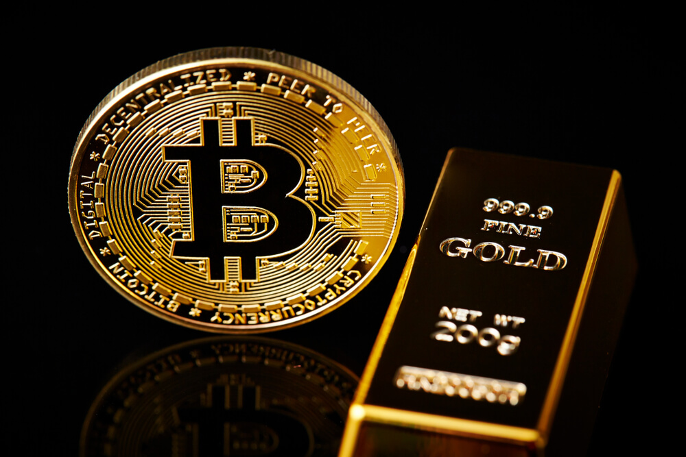 A gold Bitcoin next to a gold bar
