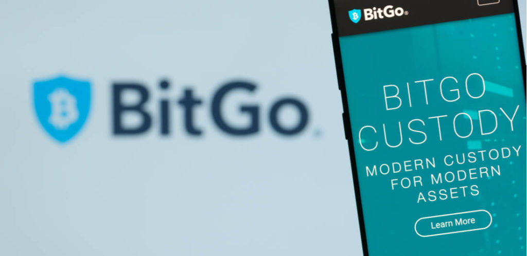 BitgGo logo with phone with Bitgo Homepage on it