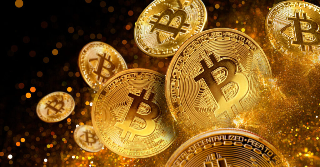 Multiple golden bitcoins falling through the air