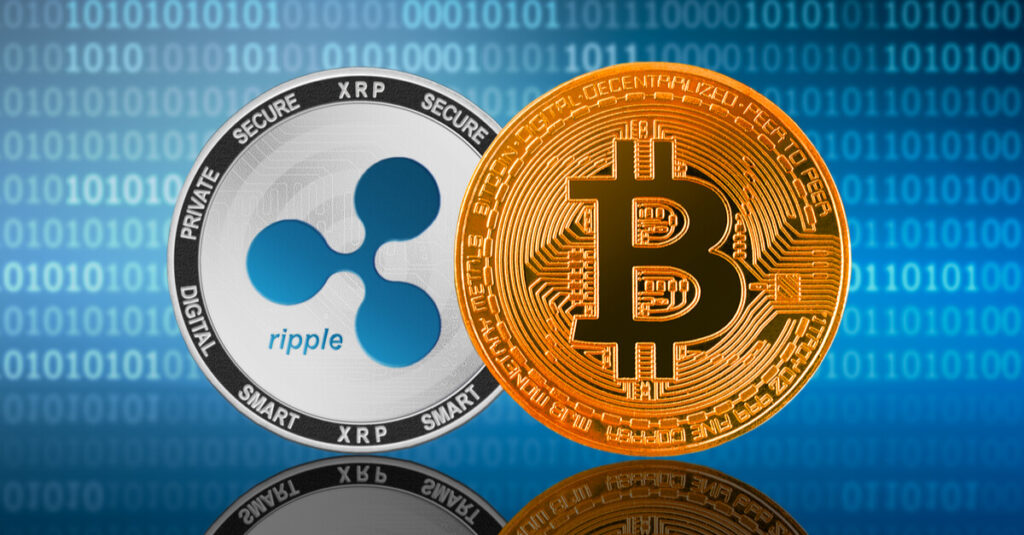 bitcoin and ripple coins on binary background