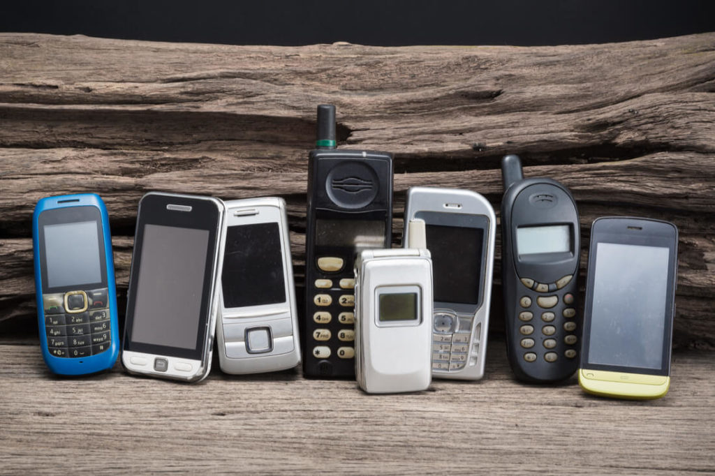 old phones in a row smart phones and dumb phones