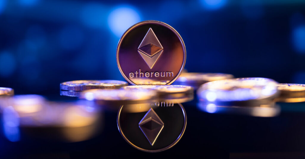 One Ethereum, represented in physical gold coin form, next to a pile of US dollars.