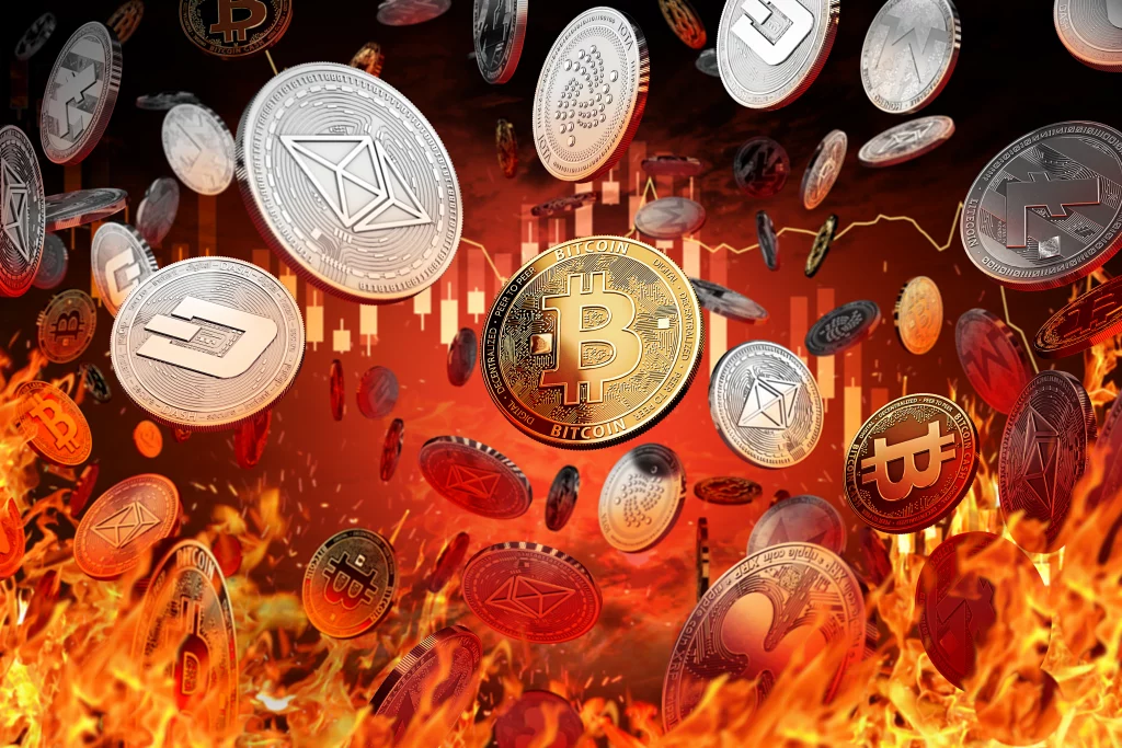 Several crypto coins dropping from the sky against a red background and flames at the bottom