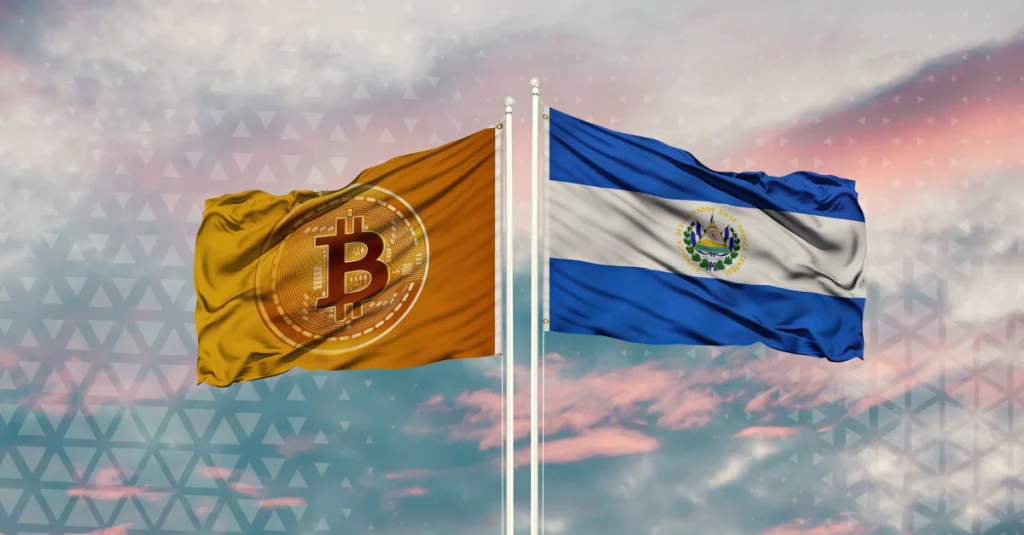A flag of the Bitcoin symbol standing next to the flag of El Salvador