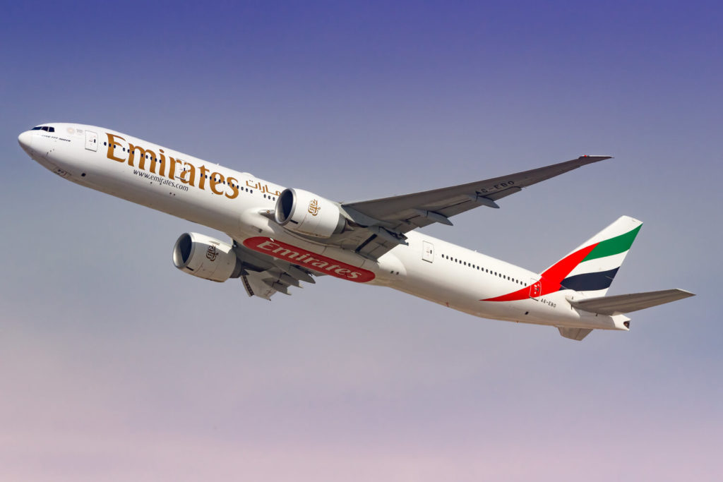 Emirates airplane flying through the sky
