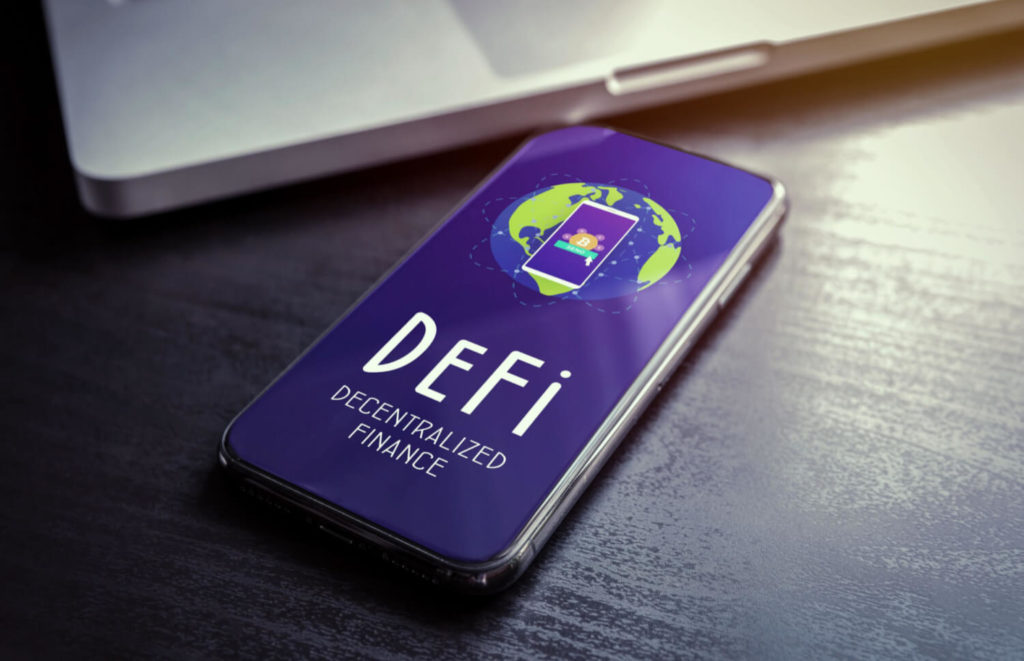 A smart phone on a desk with the words DEFI, Decentralized Finance on it