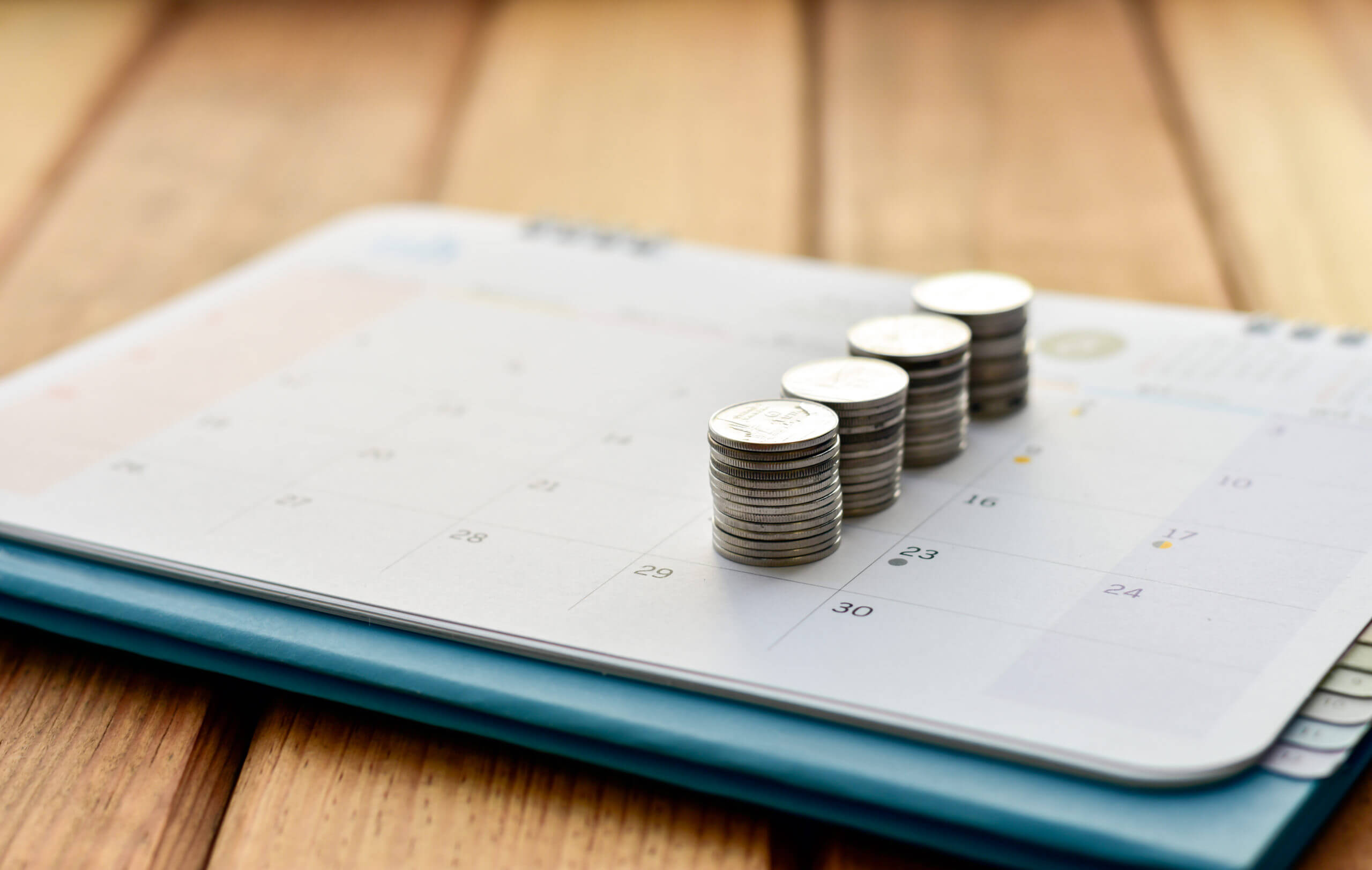 Coins placed on top of a calendar