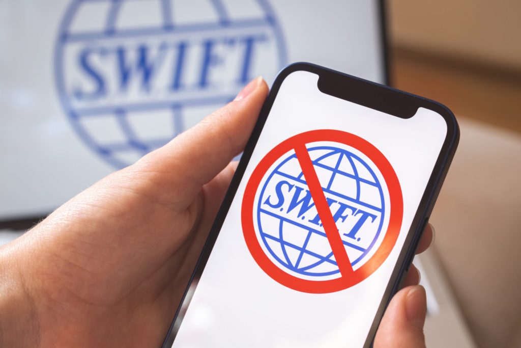 SWIFT logo with banned sign on iPhone screen