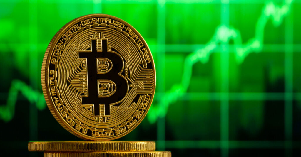 bitcoin infront of green bullish price chart