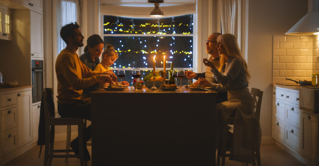 family sitting at the table at at new year's dinner party