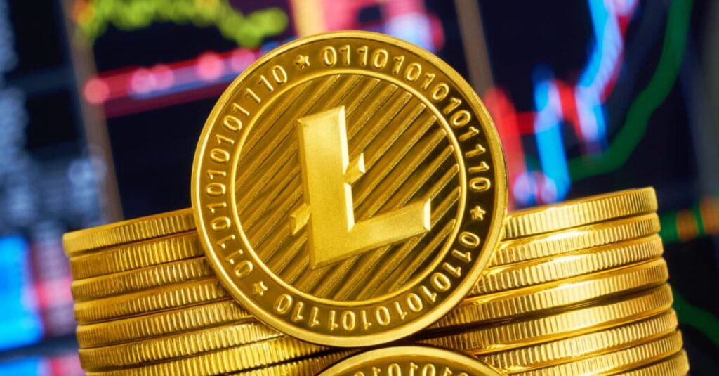 stack of gold LTC coins in front of price chart