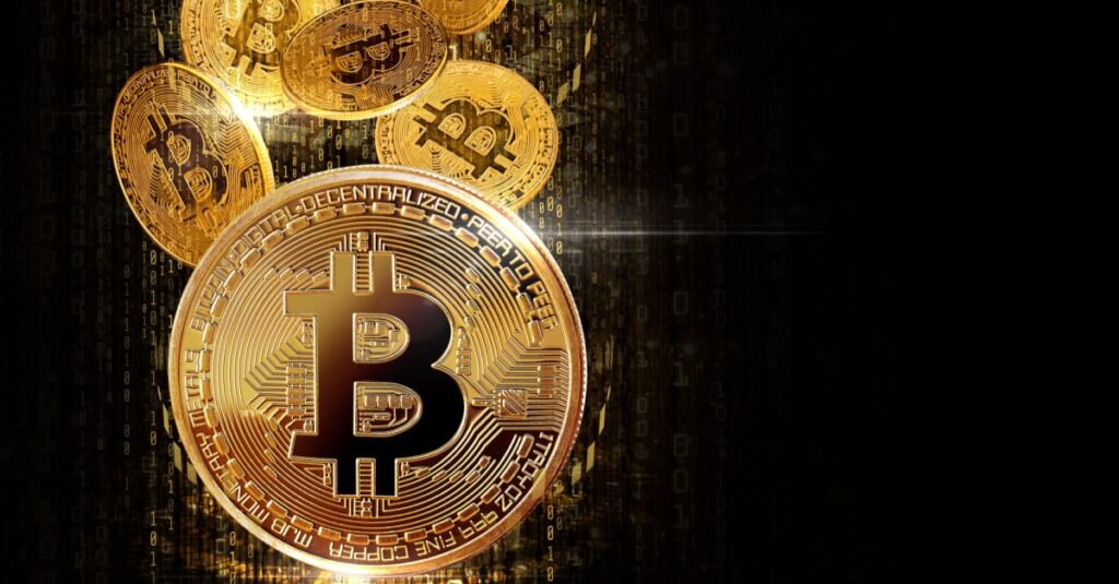 One golden bitcoin standing up with multiple golden bitcoins falling in the background