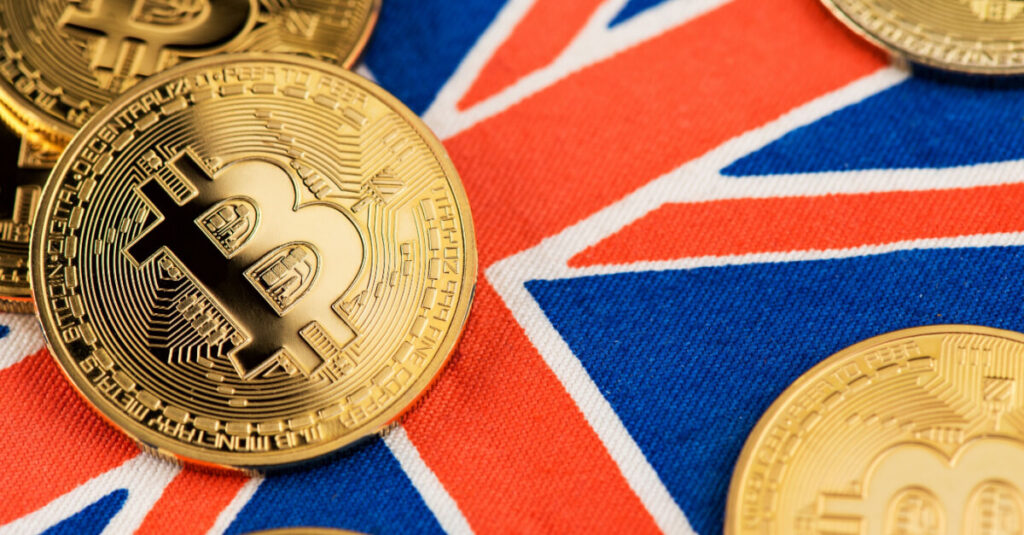  Golden bitcoin coin sitting on top of the flag for the United Kingdom
