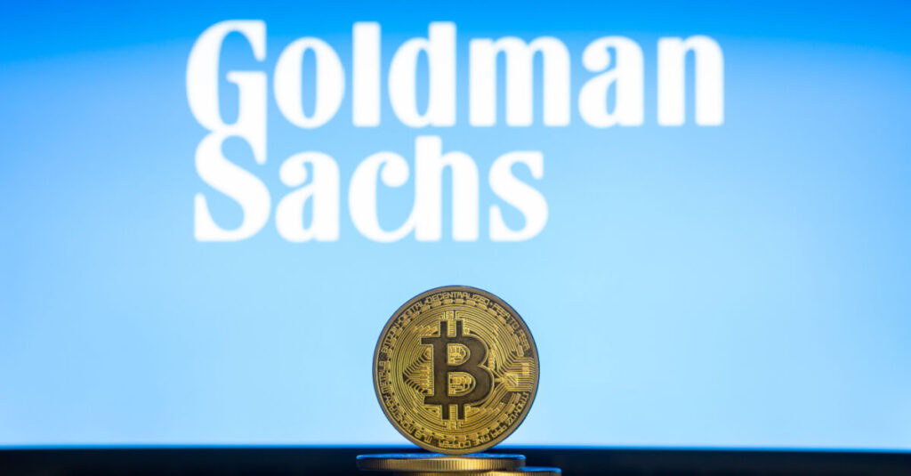 Representation of a Bitcoin in front of a displayed Goldman Sachs Logo