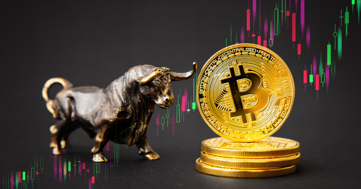 Model of a bull standing next to a golden bitcoin coin