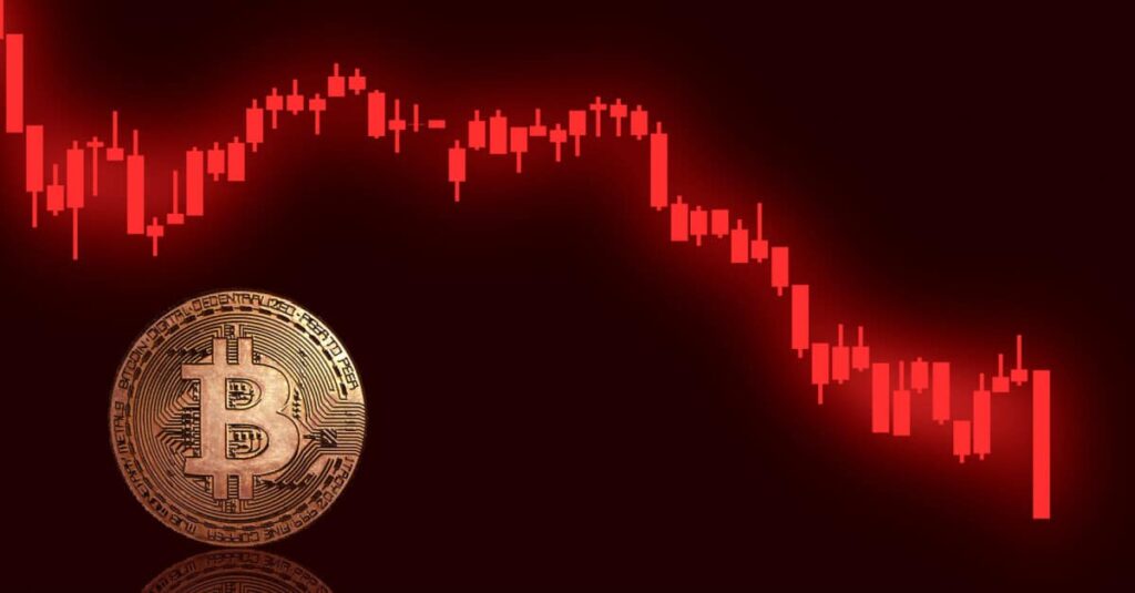 gold bitcoin in front of red bitcoin chart crashing down