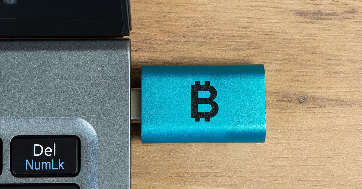 blue bitcoin wallet usb key in laptop tiny